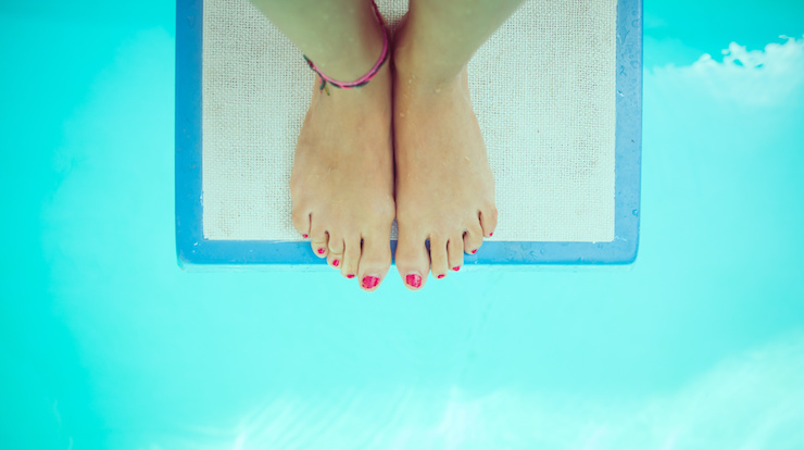 A girl with pink tow nail polish stands on a springboard over turquoise water | Weight Loss and the Waiting Trap | Progress iOS app